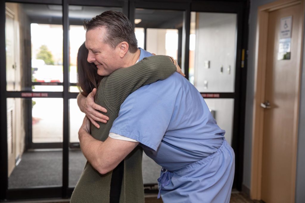 Dr. Hoeman hugs a patient